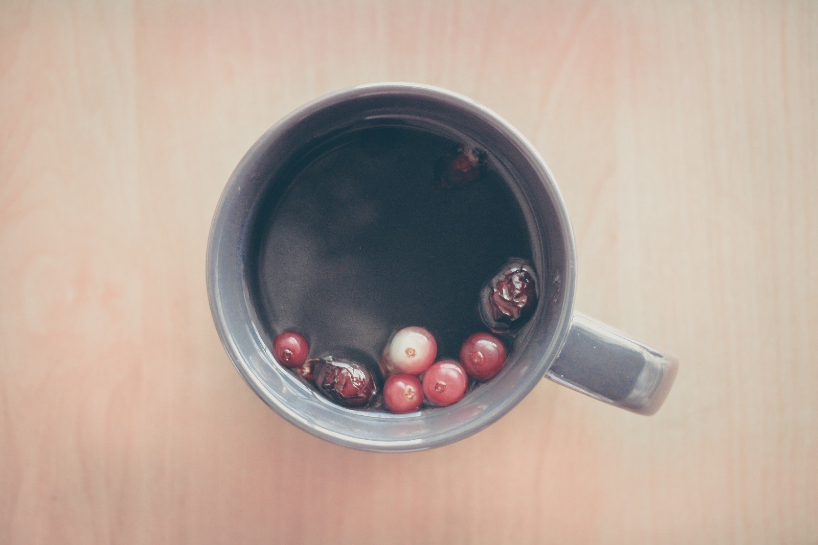 A cup of tea with berries